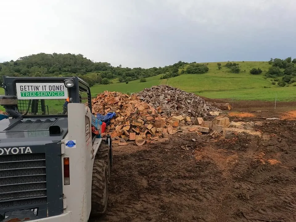 Firewood and machinery on a Shoalhaven tree services job